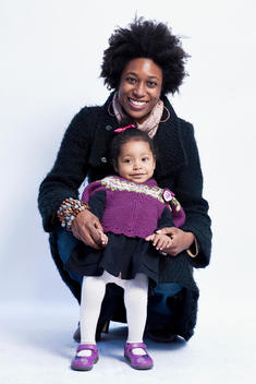 Portrait of African American mother with mixed-ethnicity, toddler, daughter, in studio