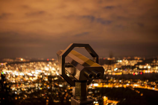 fixed binoculars with city lights in background