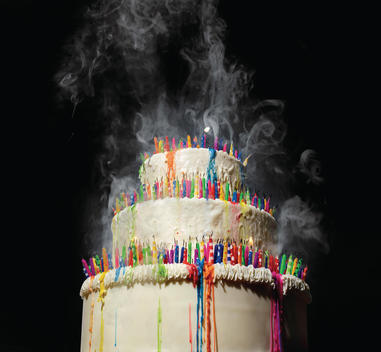 3 tiered birthday cake with blown out birthday candles