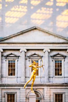 A golden statue at the center of the sculpture garden at the Metropolitan Museum of Art.