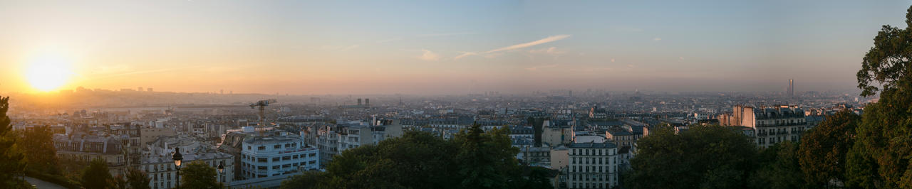 A panoramic of the sun rising over Paris from the Sacre Cour.