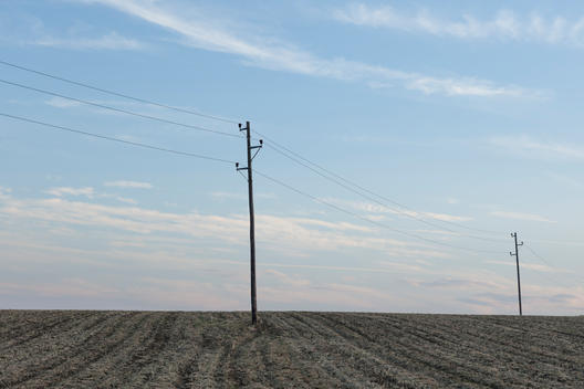 power lines crossing a ploughed field