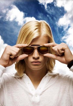 Portrait Of Blonde Man With Long Hair Wearing Sunglasses Stock