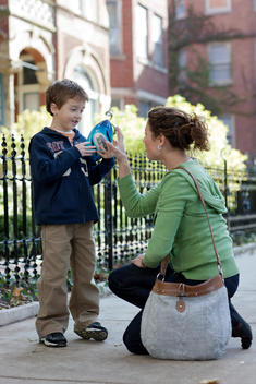A Mother Talks With Her Son On A Residential Chicago Sidewalk.