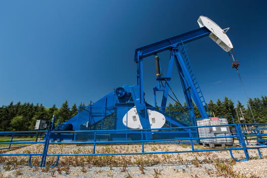 Oil well below blue sky