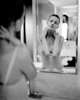 Beauty Model Looking At Self In Mirror