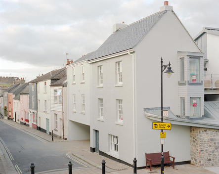 A development of hew housing in Totnes. The town\'s castle can be seen in the background. Totnes is an ancient market town on the mouth of the river Dart in Devon. The town is attempting to become a blueprint for communities to make the change from a life 