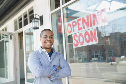 Portrait of business owner standing at new storefront