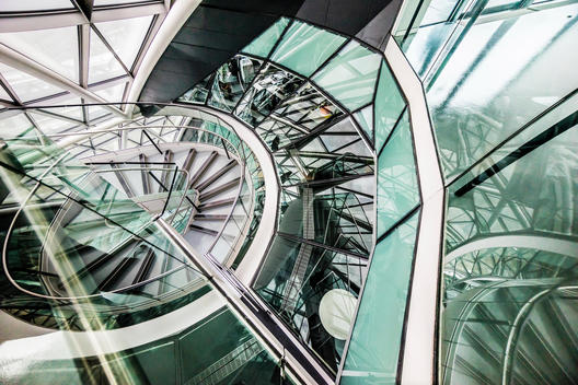 The spiral staircase in the Mayor?s office London is surrounded by glass windows that looks into offices.