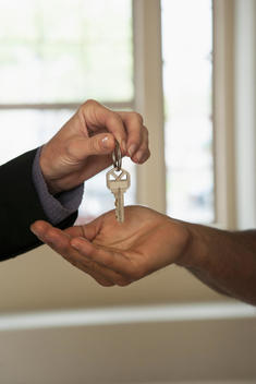 Realtor handing house keys to new owner