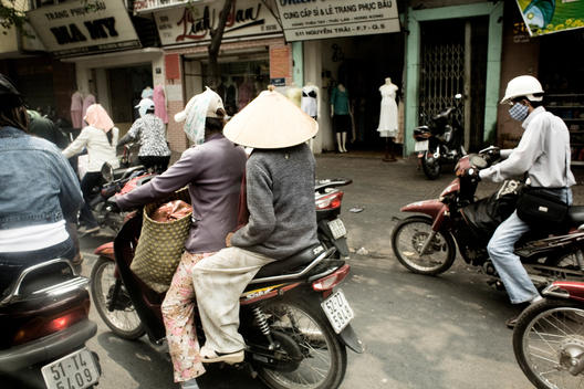 Moped Riders On Crowded Street
