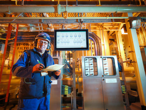 Portrait of engineer with digital display in power station
