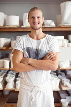 Portrait of smiling male worker in crockery workshop