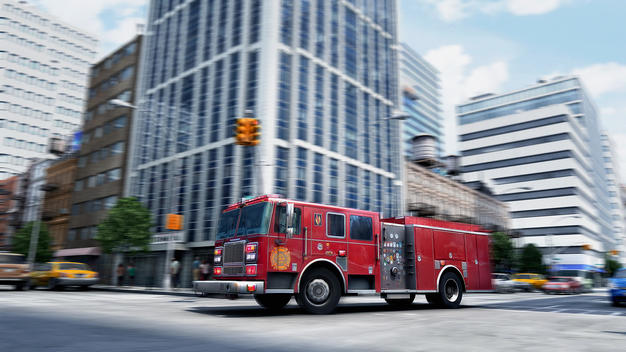 Blurred view of fire truck driving through intersection, New York, New York, United States
