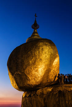 People standing at golden rock