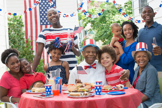 Multi-generation family smiling at Fourth of July barbecue
