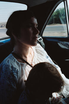 Mother In Back Seat With Child