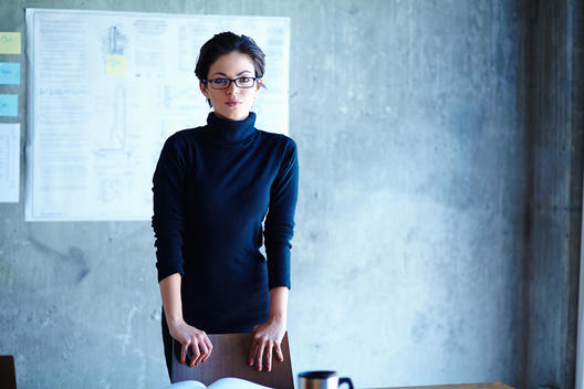 Portrait of intelligent young businesswoman in office