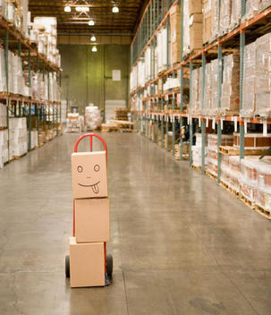 Stack of boxes in warehouse with smiley face