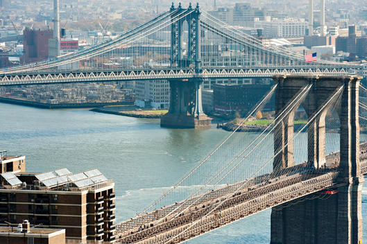 Aerial View From Manhattan On A Clear Afternoon Spanning The Brooklyn And Manhattan Bridges As They Connect The Boroughs. New York, New York.