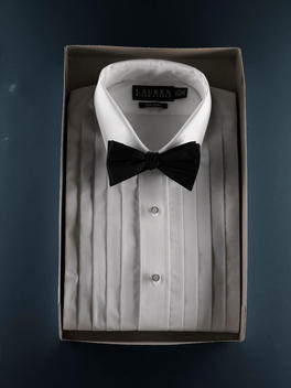 Tuxedo Shirt With Bowtie Against Solid Blue Wall