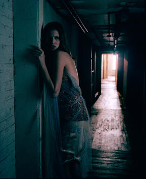 Woman lost in dark hallway