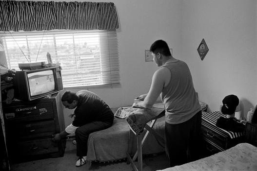 Gang members at home ironing clothes