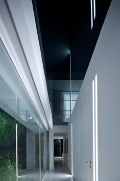 Lit hallway corridor with glass ceiling in modern white house, Israel, Middle East