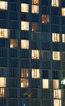 View At Dusk Of Brightly Lit Apartment Building Facade. New York, New York.