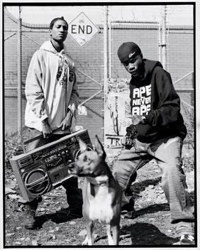 young adults with a boom box and a dog