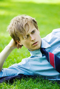 Man Wearing A Shirt And Tie While Lying On Grass Relaxing
