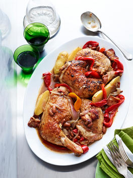 Plate of spanish chicken with potato, red pepper and beans