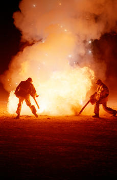 Two Men Dressed In Fire Suits, Use A Leaf Blower, 300Lb Of Flour And A Tank Of Petrol To Create A Fire Cyclone, At Desert Blast - A Secret Gathering Of Pyrotechnic Enthusiasts And A Private Fireworks Party Held At A Hidden Location In The Nevada Desert.