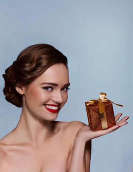 Beauty portrait of woman holding gift box