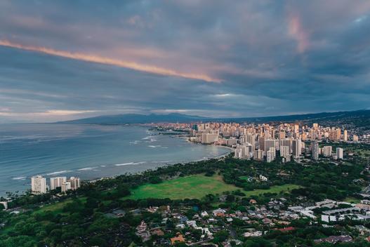 Photo of Waikiki in Honolulu, Hawaii from the top of Diamond Head Crater at sunrise.