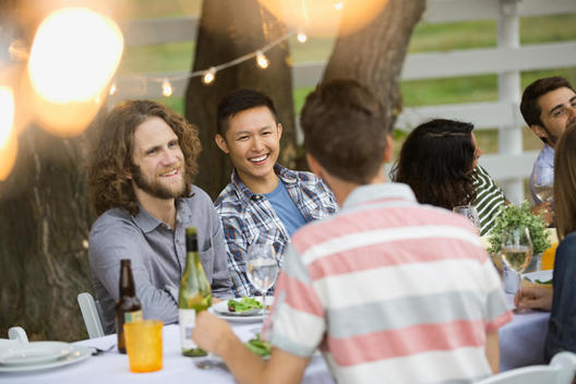 Multiethnic friends enjoying outdoor dinner party
