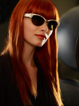 Model With Long Red Hair Wearing Sunglasses