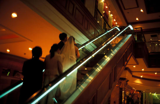 Wedding Party Ascending Escalators Of Ramada Plaza Hotel, Nanjing Road, Shanghai, China.