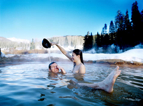 Couple Relax In Outdoor Hot Tub In Snow