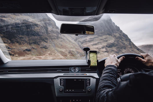 A drivers point of view from inside the car, with an oncoming large HGV lorry vehicle whilst driving away from Glencoe in the Scottish Highlands