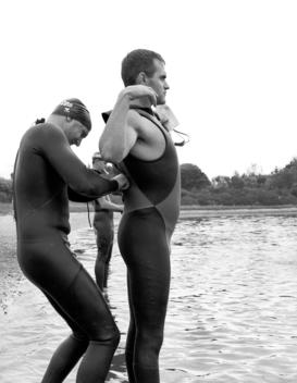 Athletes Help Each Other Prepare For Upcoming Race In Montauk, New York, Usa.
