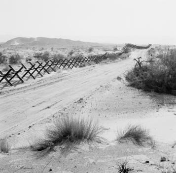 Calexico, California USA August 20, 2007 In 2007 the National Guard has placed miles of vehicles barriers along a western stretch of open desert that marks the border between the US and Mexico. The barrier now blocks what was once an open road for smuggle