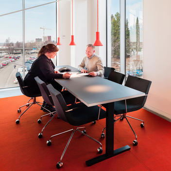 Workers at a meeting in contemporary office designed by Link Arkitektur, Umeaa, Sweden.