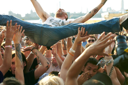 Man Crowd Surfing At Outdoor Concert