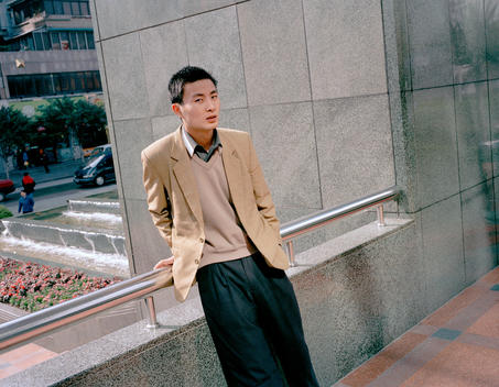Man standing outside of a shopping mall, Guangzhou, China, 2003.