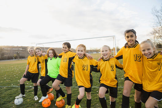 Girls soccer team standing on field