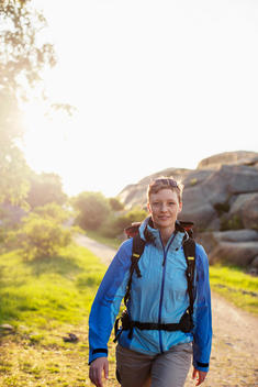 Portrait of female backpacker hiking outdoors