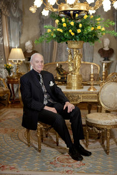 Portrait Of A Man Sitting On A Chair In A Formal Living Room