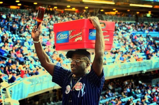 A vendor selling cold beer to the crowds at a baseball game at Yankee Stadium. Bronx, New York City.