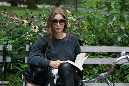 Girl reading a book in the park.